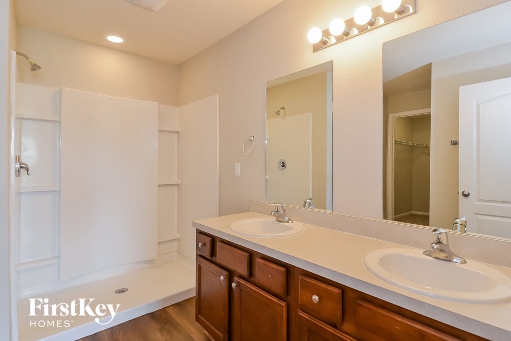 a bathroom with two sinks and a large mirror