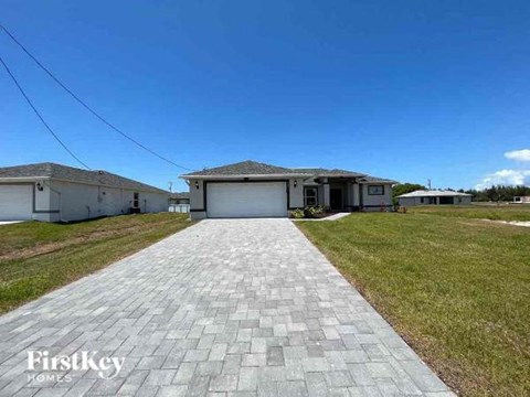 a paved driveway in front of a house