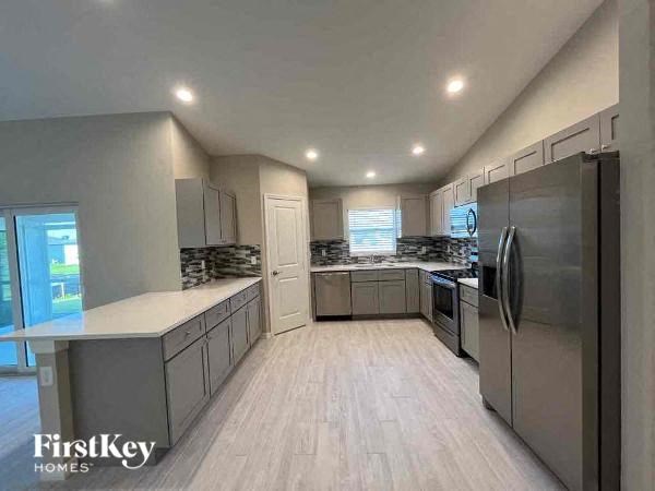 A modern kitchen with a FirstKey Homes logo.