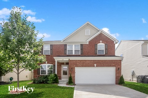 a brick house with a white garage door