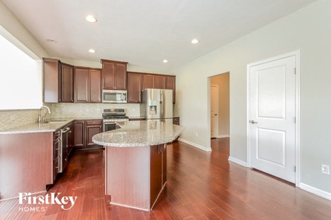 a kitchen with wood flooring and granite counter tops and