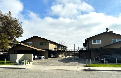 A large building with a parking lot in front.