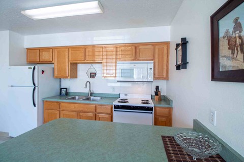 a kitchen with wooden cabinets and a counter top