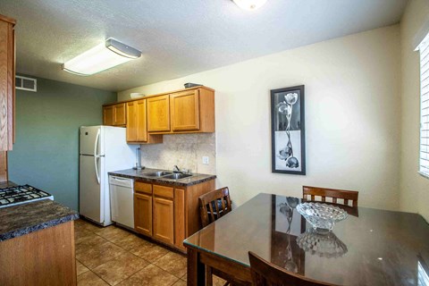 a kitchen with a dining table and a refrigerator