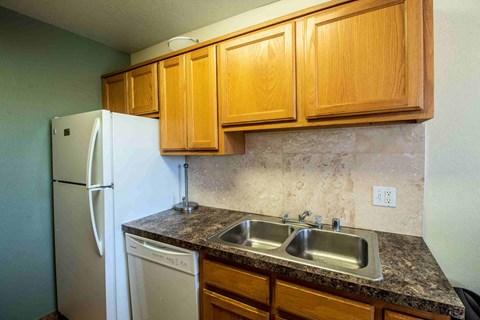 a kitchen with a sink and a refrigerator