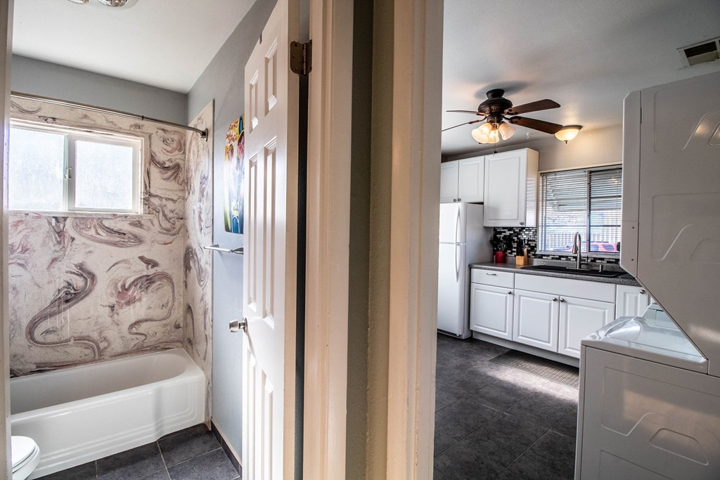 the view of the kitchen from the bathroom with the door open
