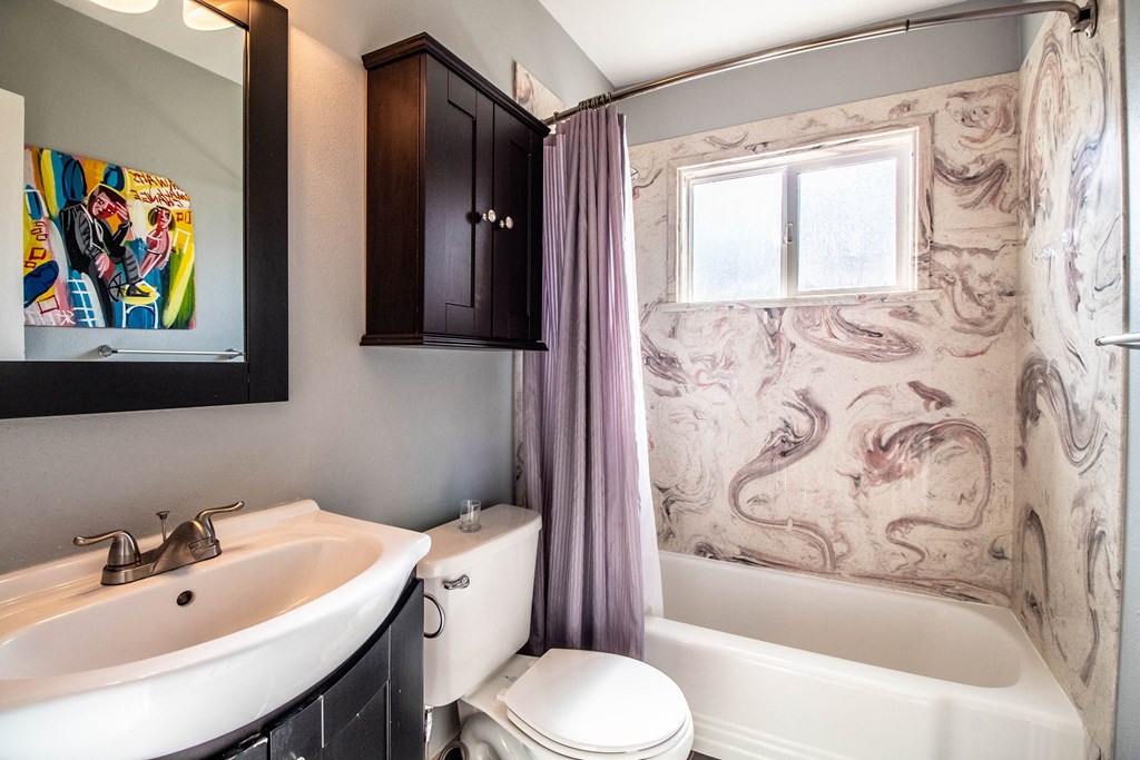 a bathroom with a sink toilet and a tub