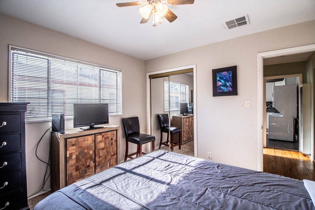 the view of a bedroom with a large bed and a tv