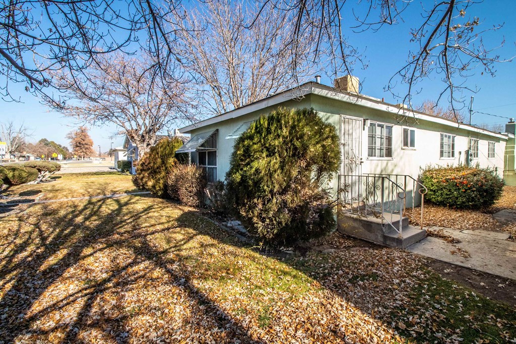 a blue and white house with a yard and stairs