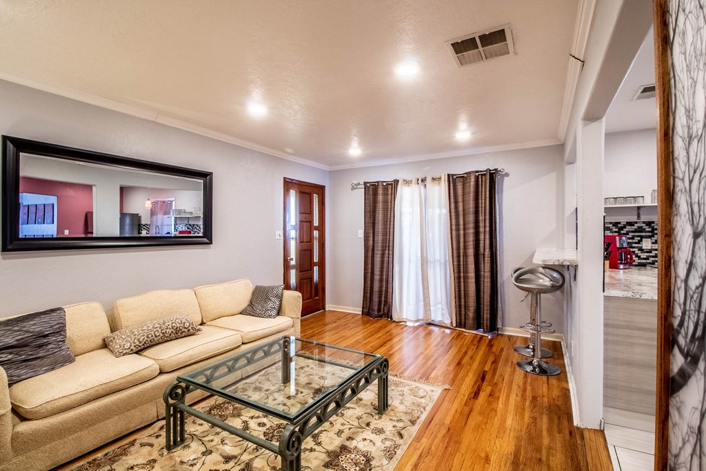 a living room with a couch and a glass coffee table