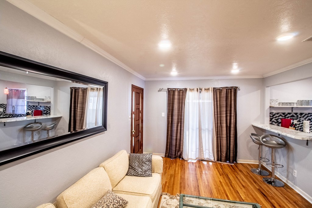 a living room with a couch and a mirror