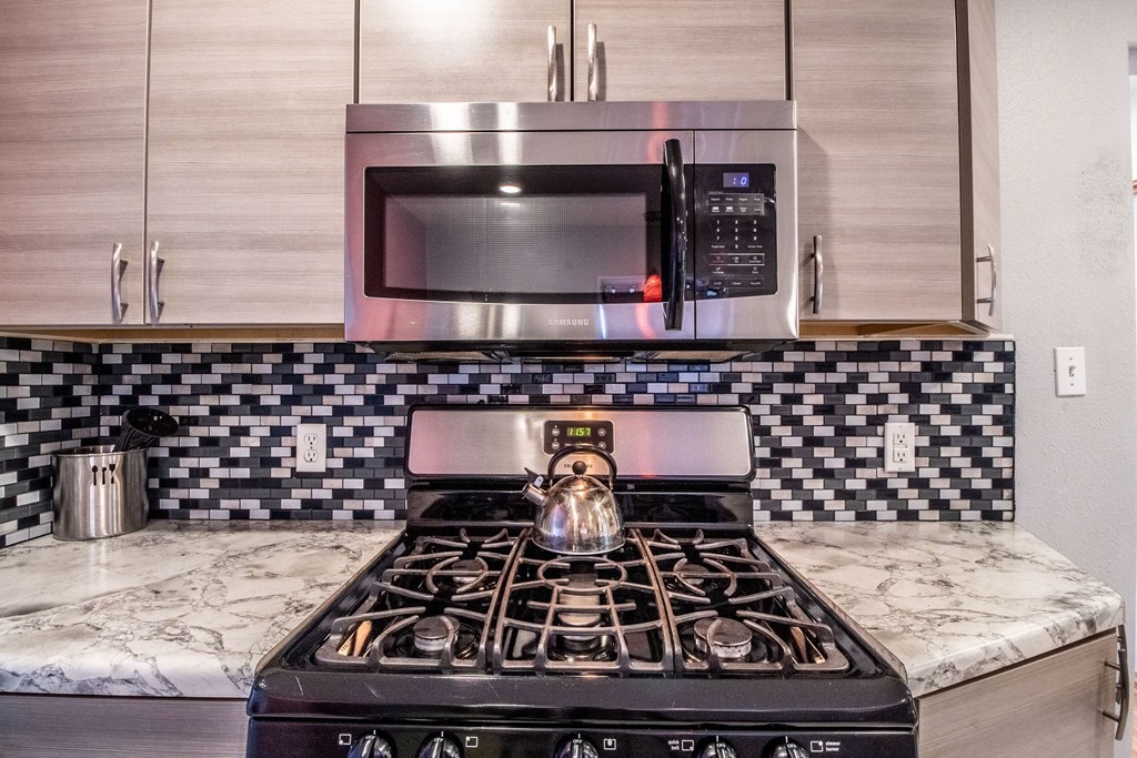 a kitchen with a stove and a microwave