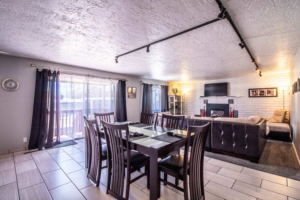 a dining room and living room with a table and chairs