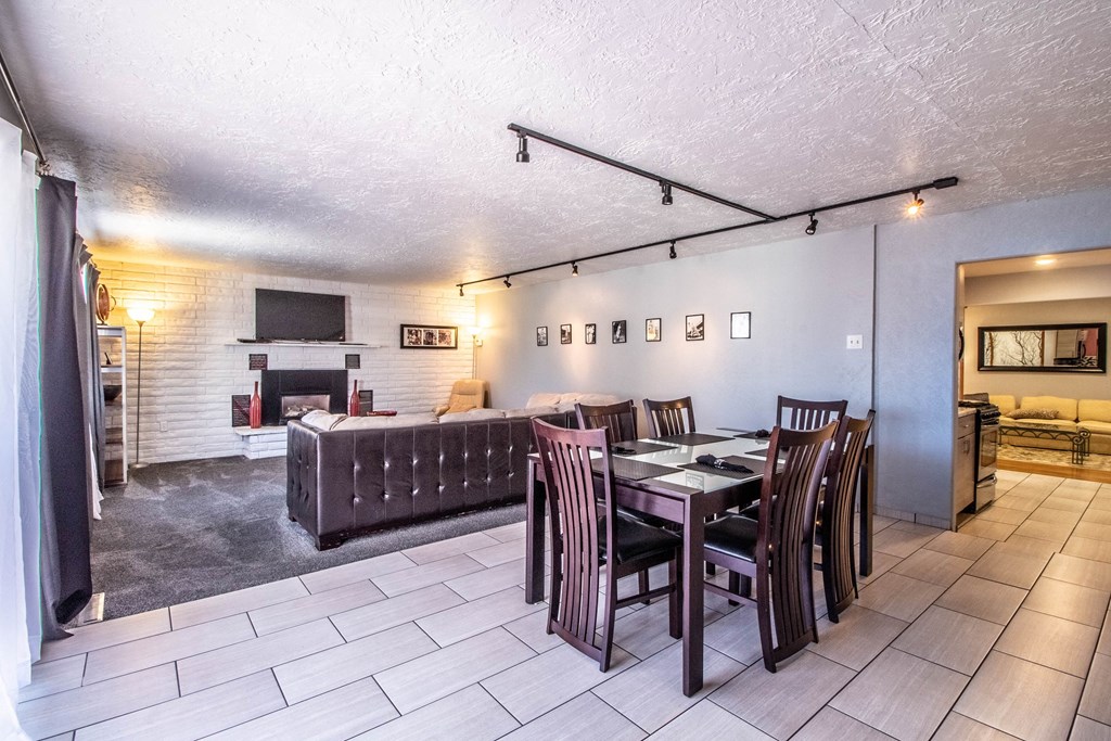 a dining room and living room with a table and chairs