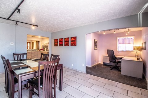 a dining room and living room with a table and chairs
