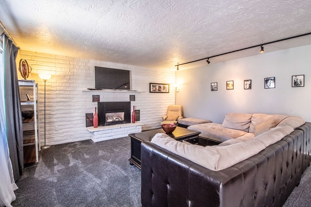 a living room with a couch and a fireplace