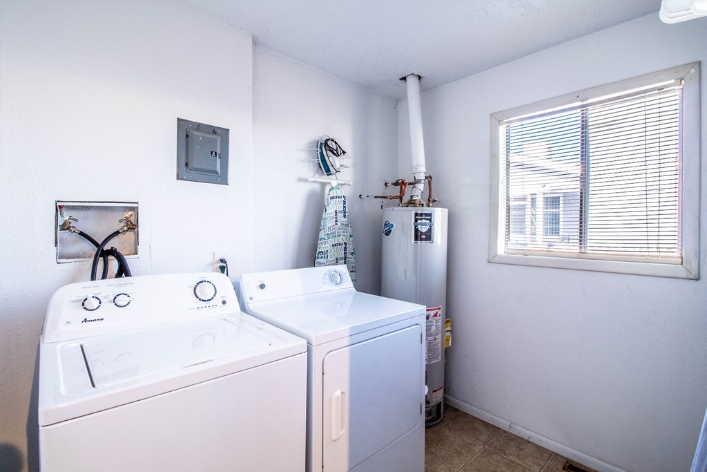 a washer and dryer in a laundry room with a window