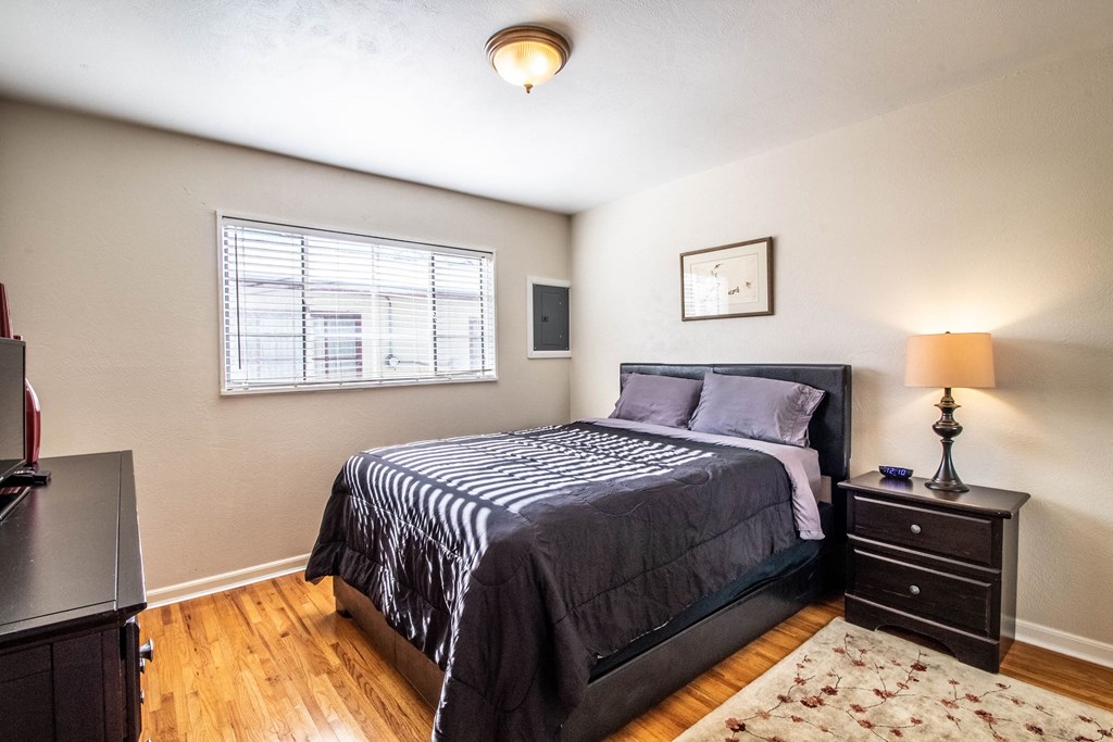 a bedroom with a bed and a window