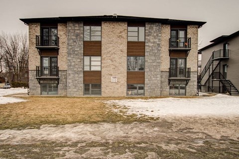 a brick apartment building with snow in front of it