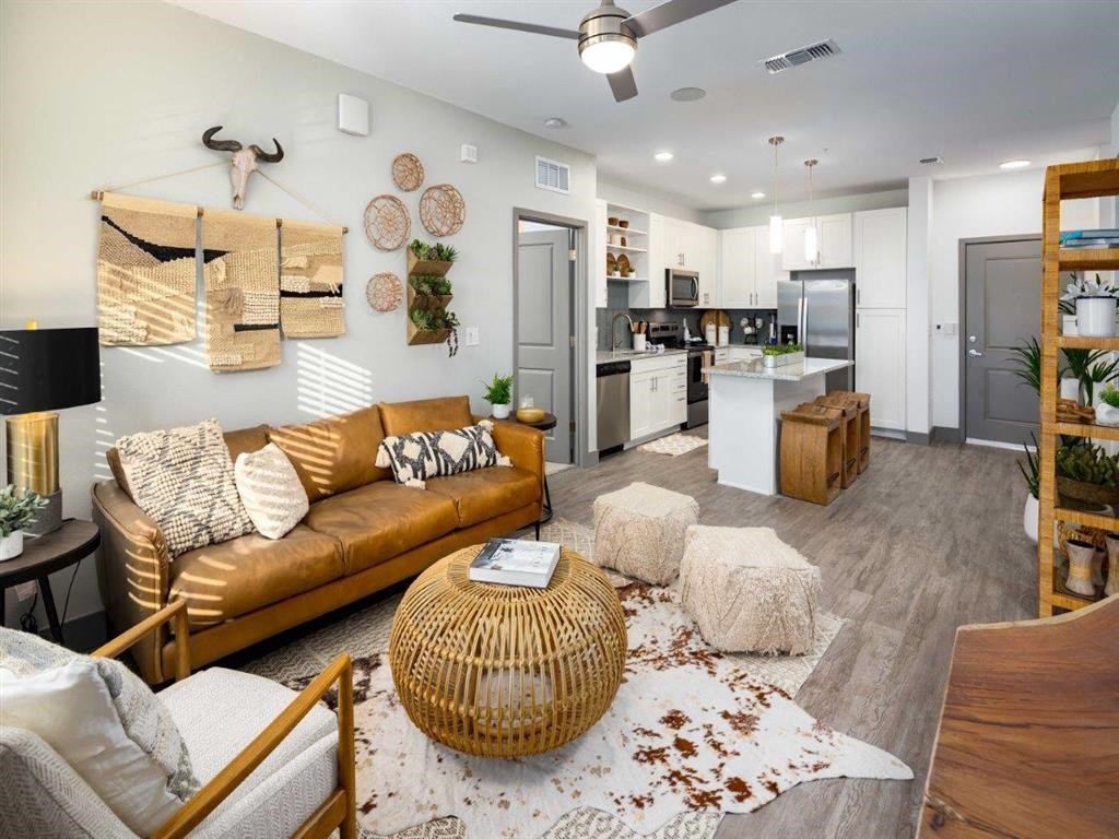 a living room and kitchen with a couch and a table