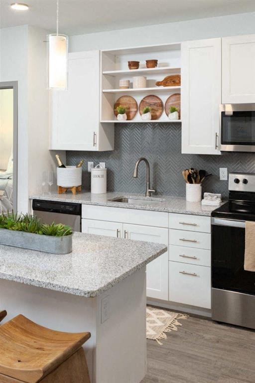 a kitchen with white cabinets and a counter top