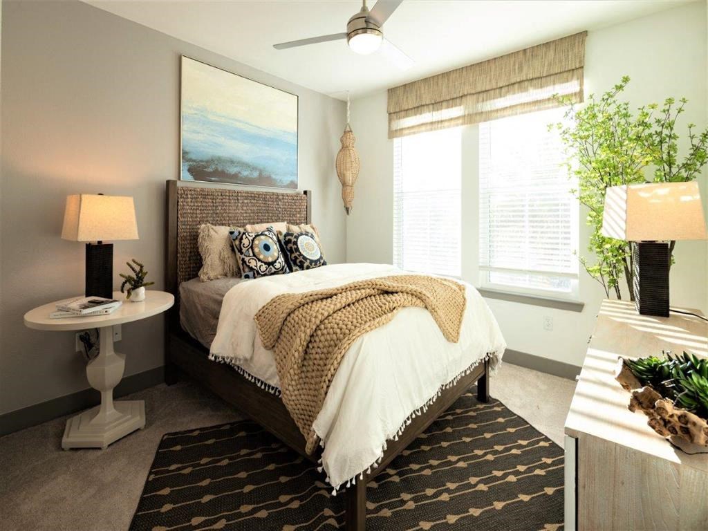 a bedroom with a bed and a large window