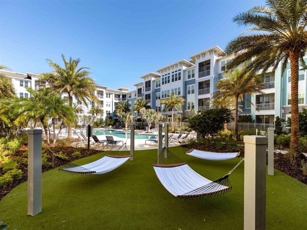 a group of hammocks in front of an apartment building