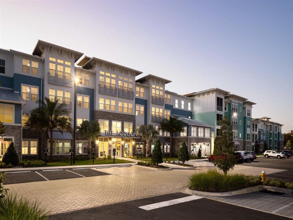 an exterior view of an apartment building at dusk
