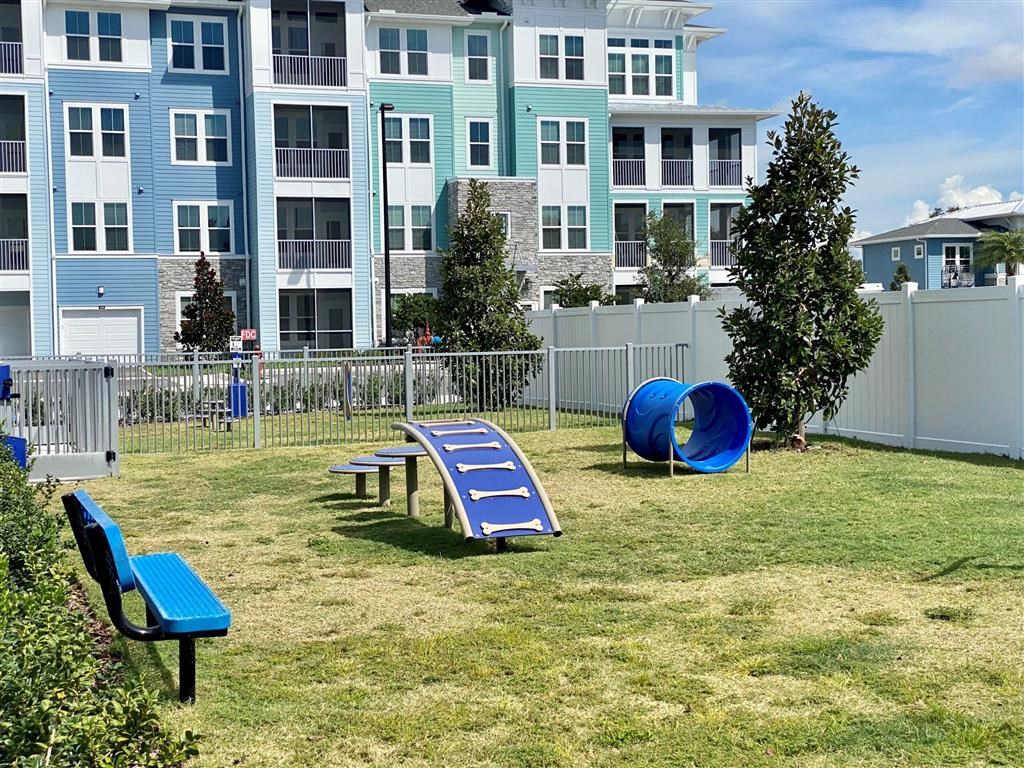 an apartment building with a playground and a picnic table