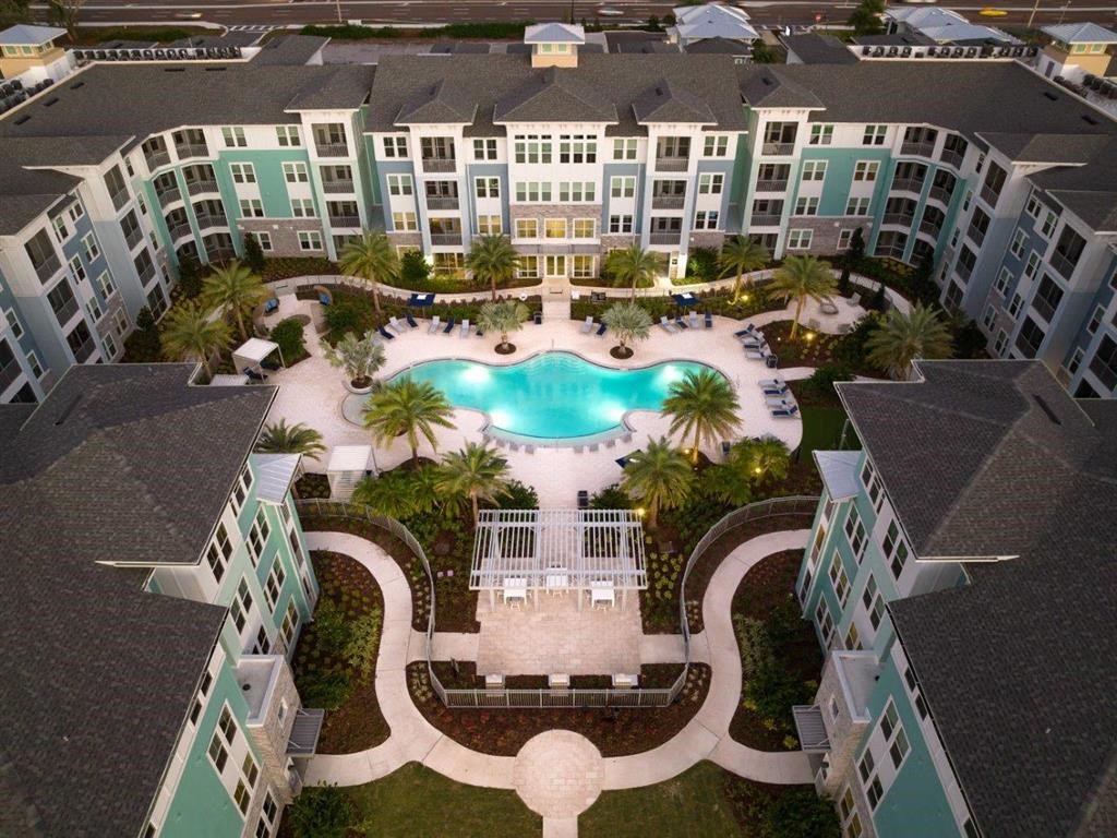 an aerial view of a large swimming pool in an apartment complex