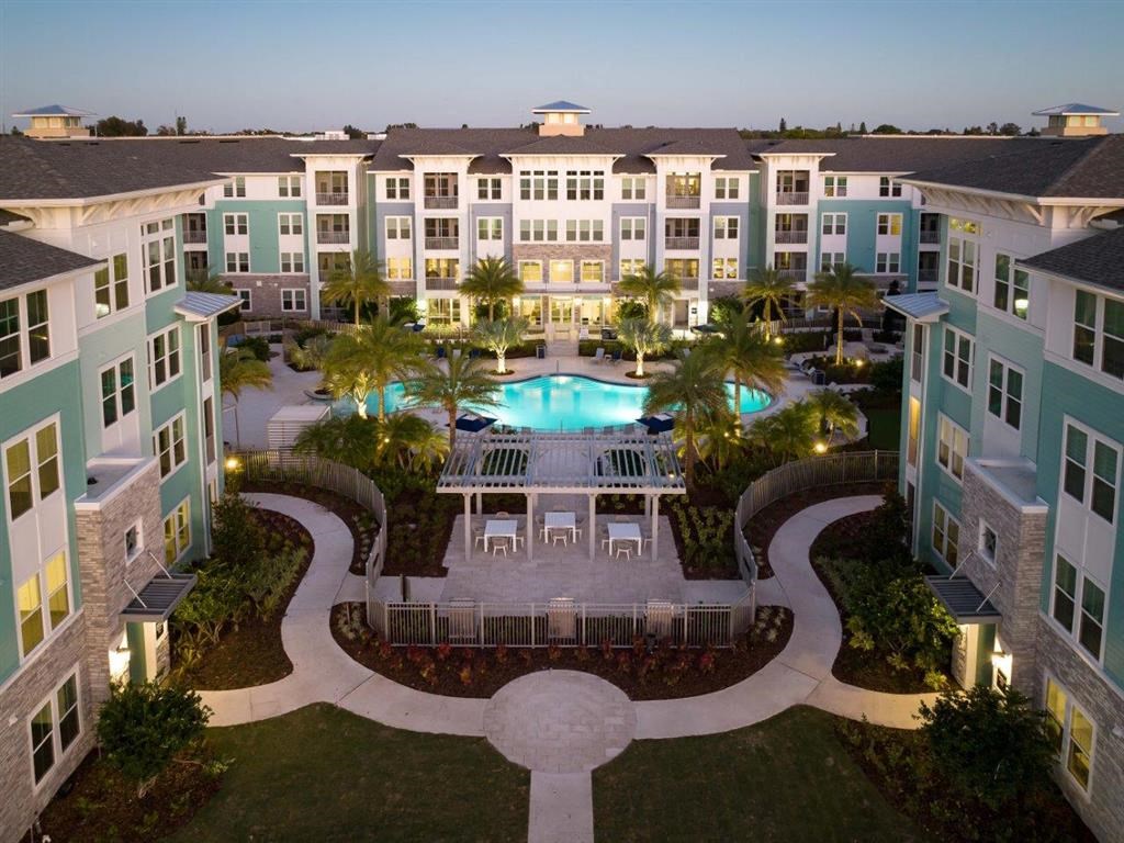 an aerial view of a large building with a swimming pool
