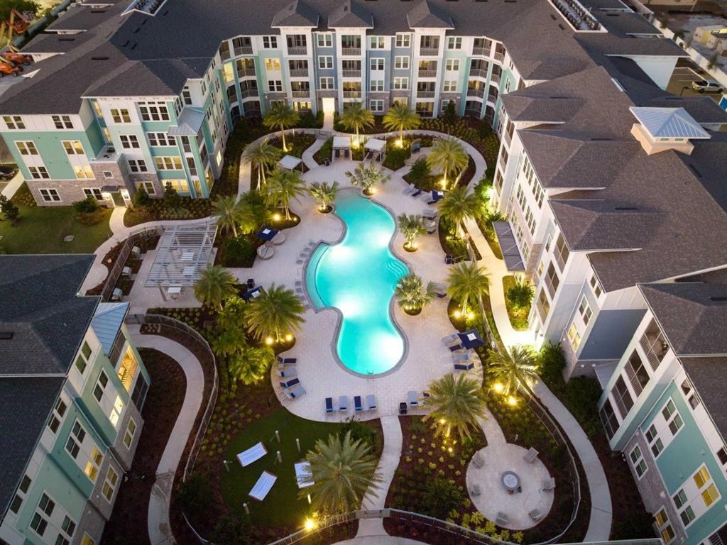 a view of the pool from above at the apartments