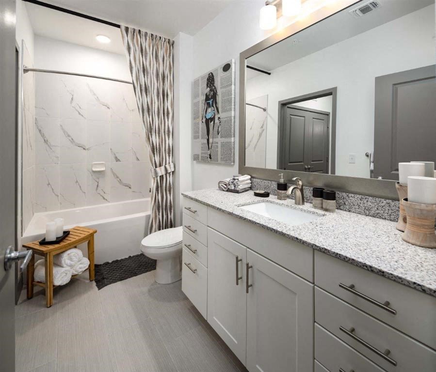 a bathroom with a sink and a toilet and a shower