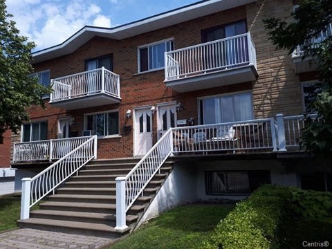 a brick building with stairs and balconies