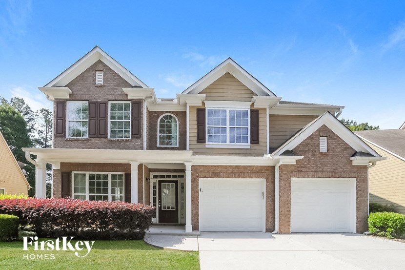 a house with two garage doors and a lawn