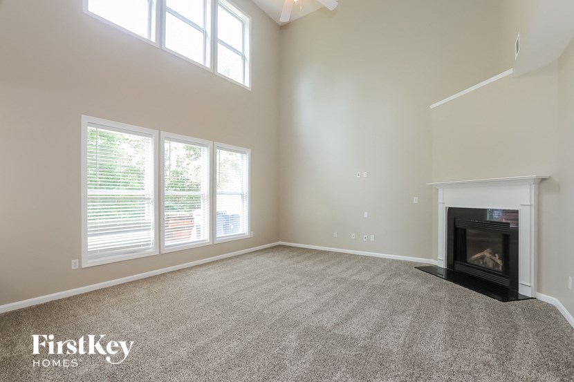 the living room of an empty house with a fireplace
