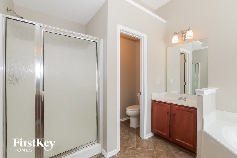 a bathroom with a shower and a sink and a toilet
