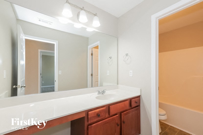a bathroom with a large mirror and a sink