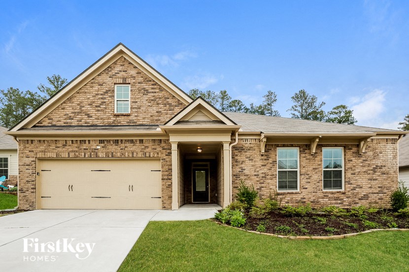 a brick house with a tan garage door