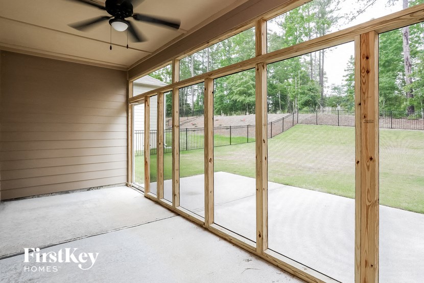 the screened porch has a view of the yard and the sliding glass doors
