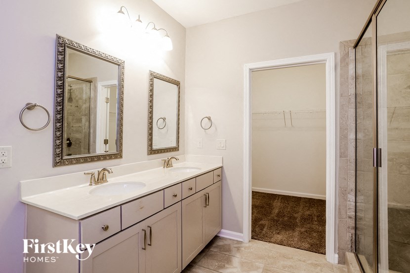 a bathroom with a sink and a mirror and a shower
