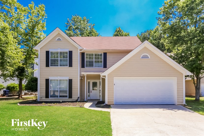 a beige house with a white garage door