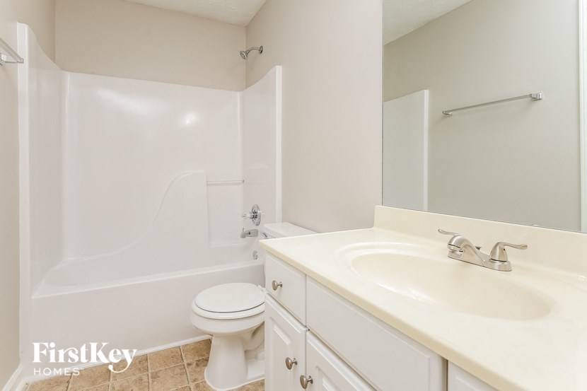 a bathroom with a sink toilet and a bath tub