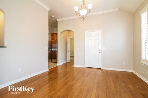 A room with wooden floors and a chandelier.