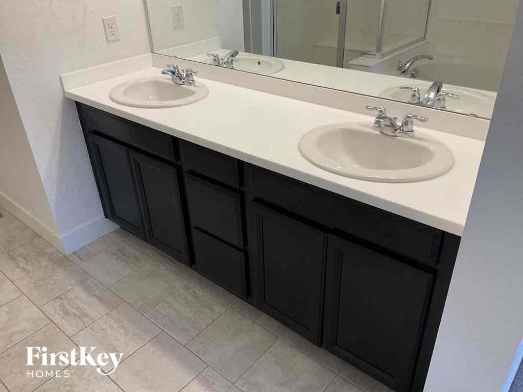 a bathroom with two sinks and a mirror