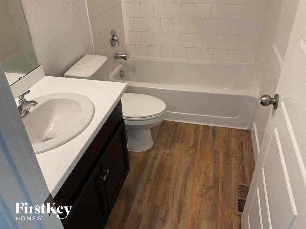 a bathroom with a sink toilet and a bath tub