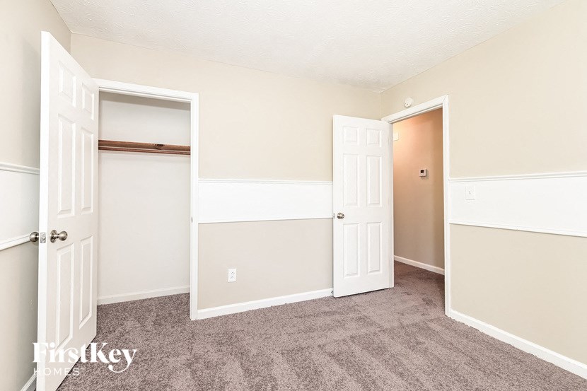 a bedroom with a closet and an open door
