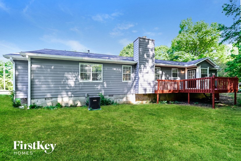 a blue house with a deck and a red deck