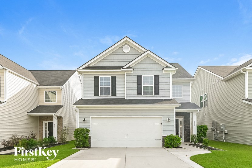 a white house with a white garage door