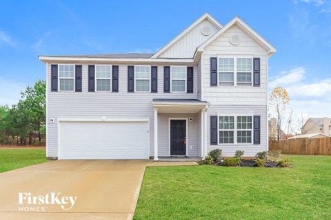 A two-story house with a garage is for sale by FirstKey Homes.